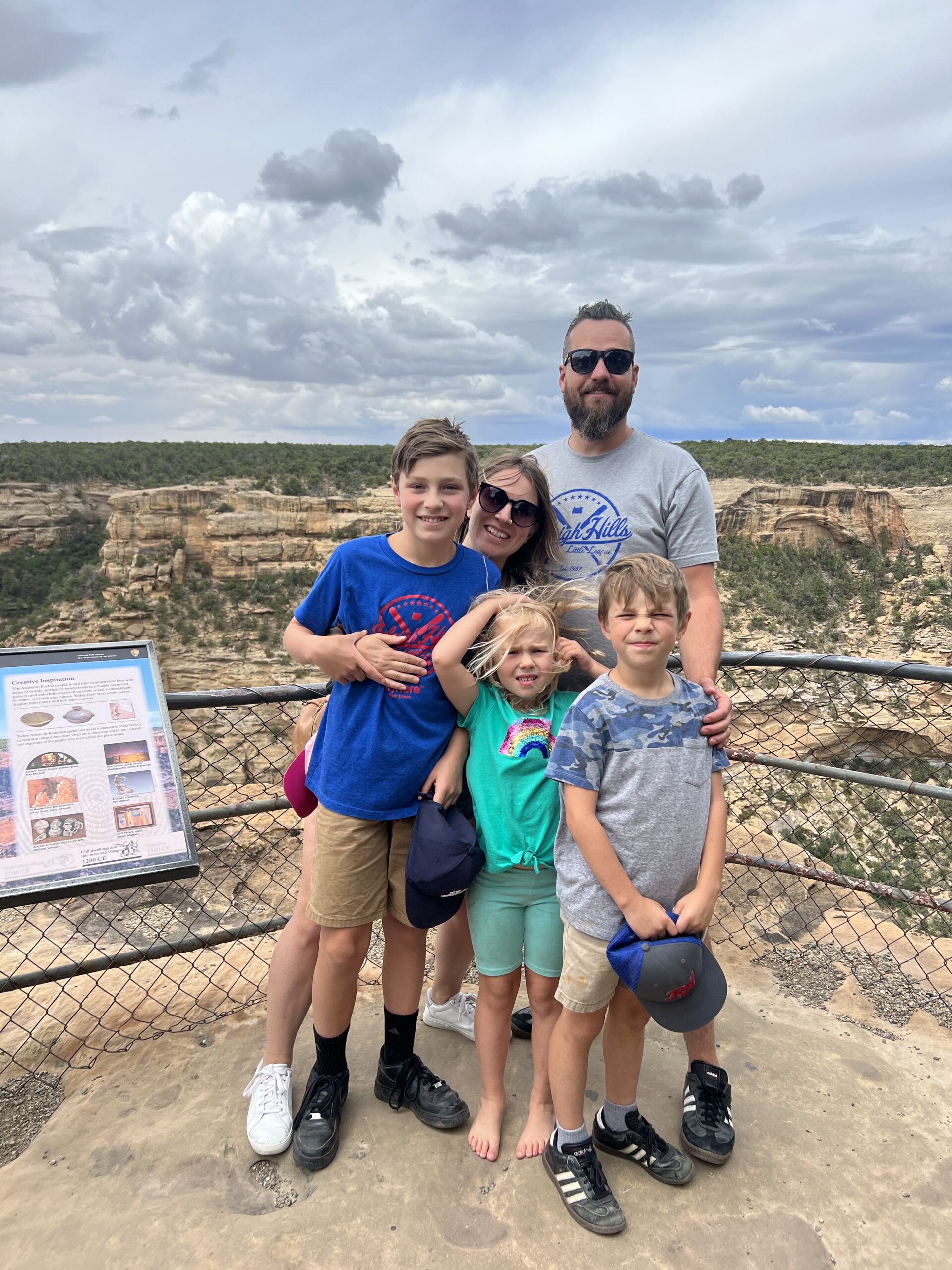The Wise family standing at a sandstone rock formation on an outdoor adventure, demonstrating the functional strength and recovery built through consistent training at APEX PWR in Tigard, Oregon