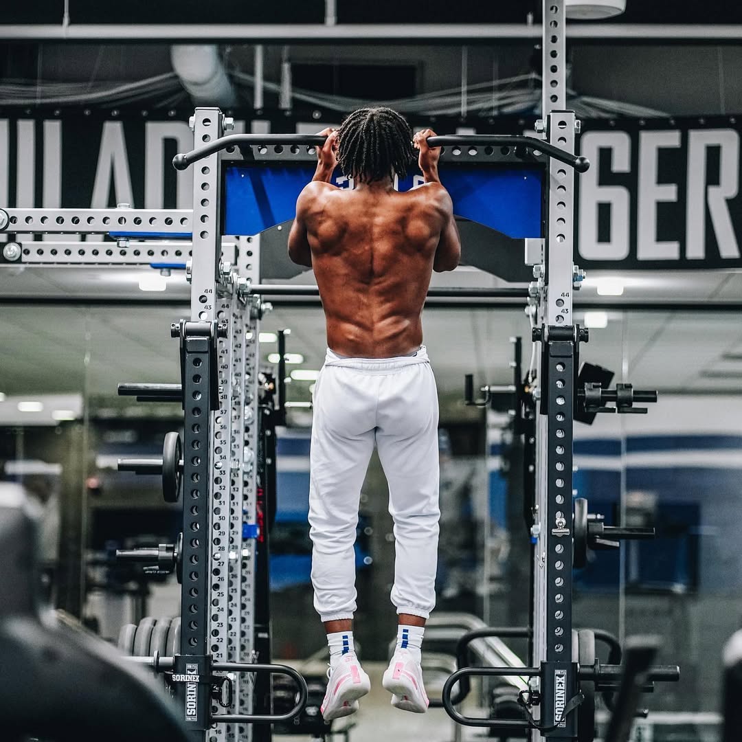 Tyrese Maxey performing weighted pull-ups in the 76ers weight room, demonstrating in-season athlete strength training