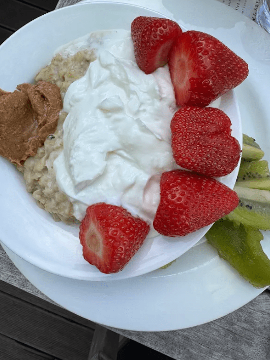 Jennie Carolan's consistent travel breakfast: Greek yogurt with peanut butter, oatmeal, strawberries, and kiwi, assembled every morning of the Europe trip