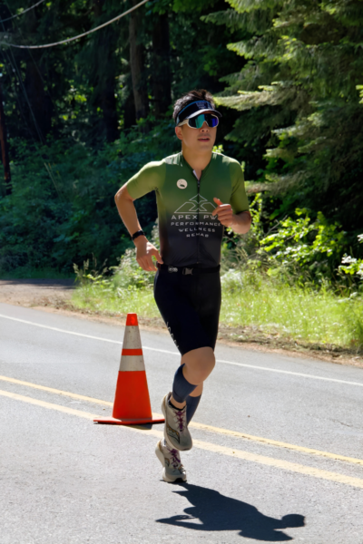Dr. Kevin Le, DPT, triathlon champions celebrating, Kevin and Batya, first place finishers, APEX PWR athletes, endurance meets recovery, strength through sport, triathlete physical therapist, training for Kona, performance-driven rehab, Tigard OR clinic, VO2 Max testing, DEXA body scans, weekly Run Club, community endurance support, athletic success story